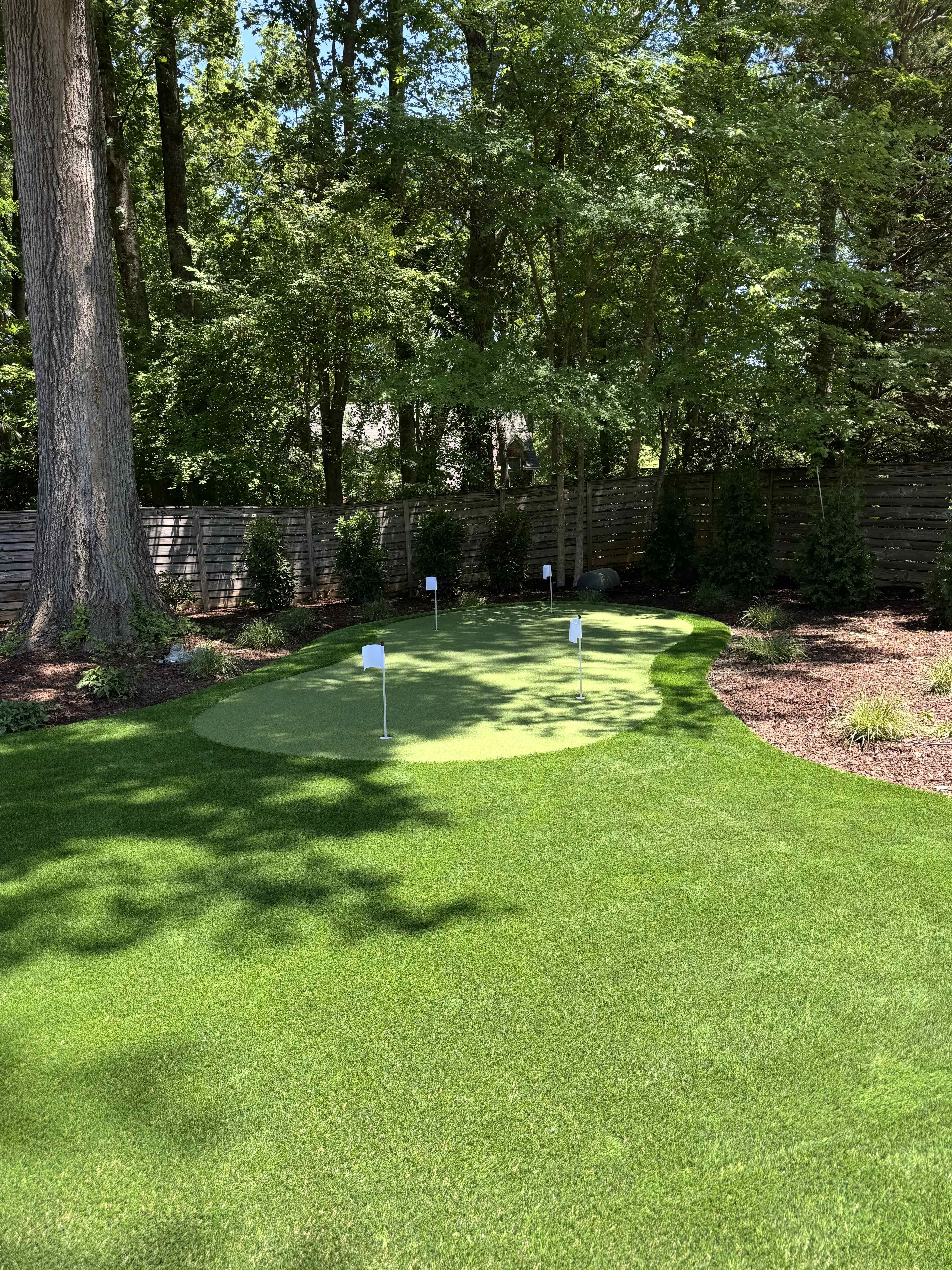 Putting Green & Full Backyard Lawn — Wooded Cedar Fence