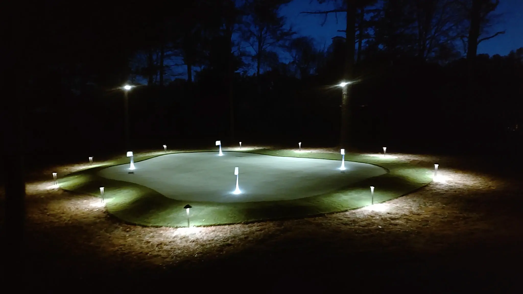 Custom multi-hole backyard putting green with night lighting