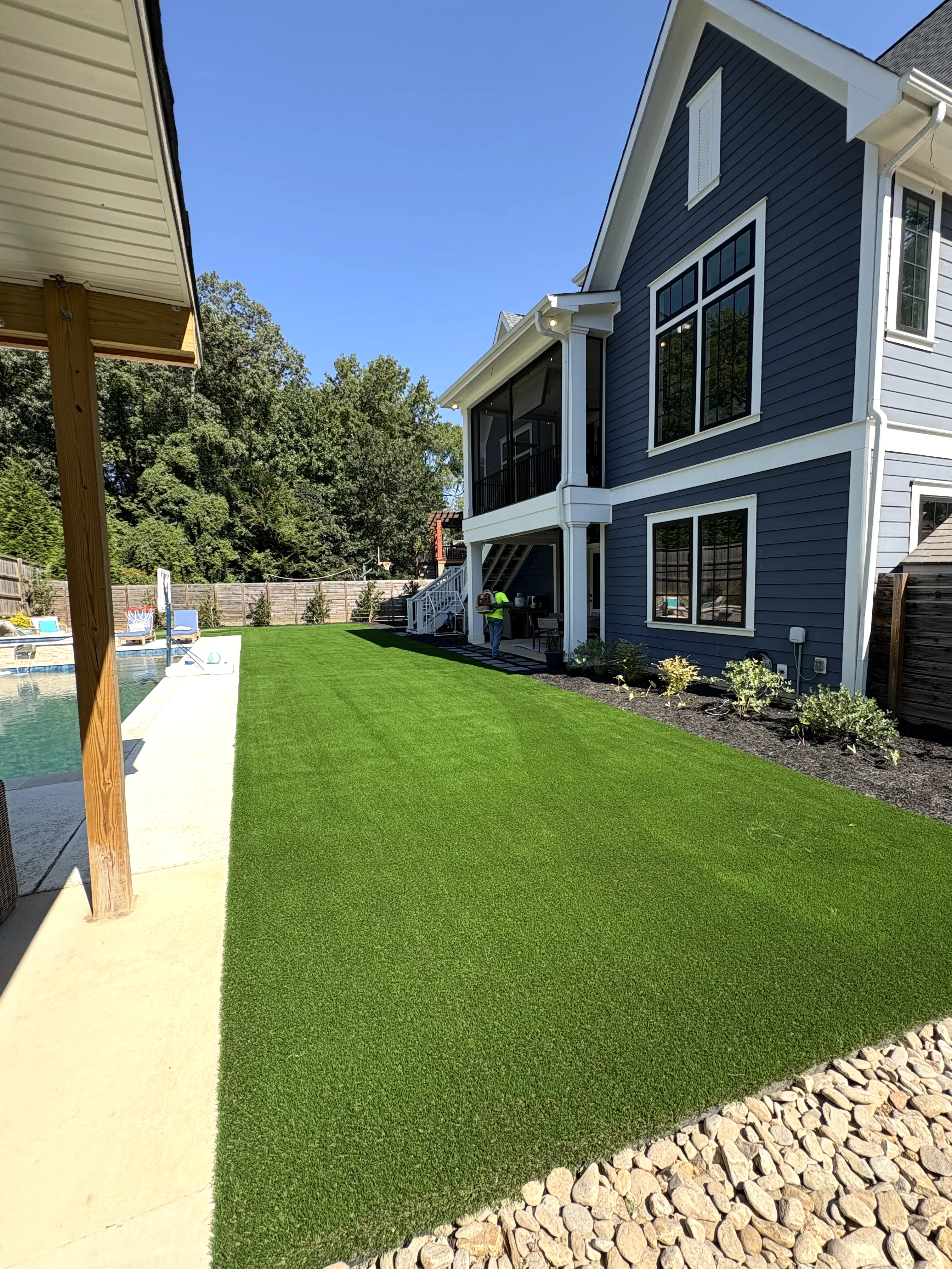 Lush residential artificial turf lawn installation in Charlotte NC backyard