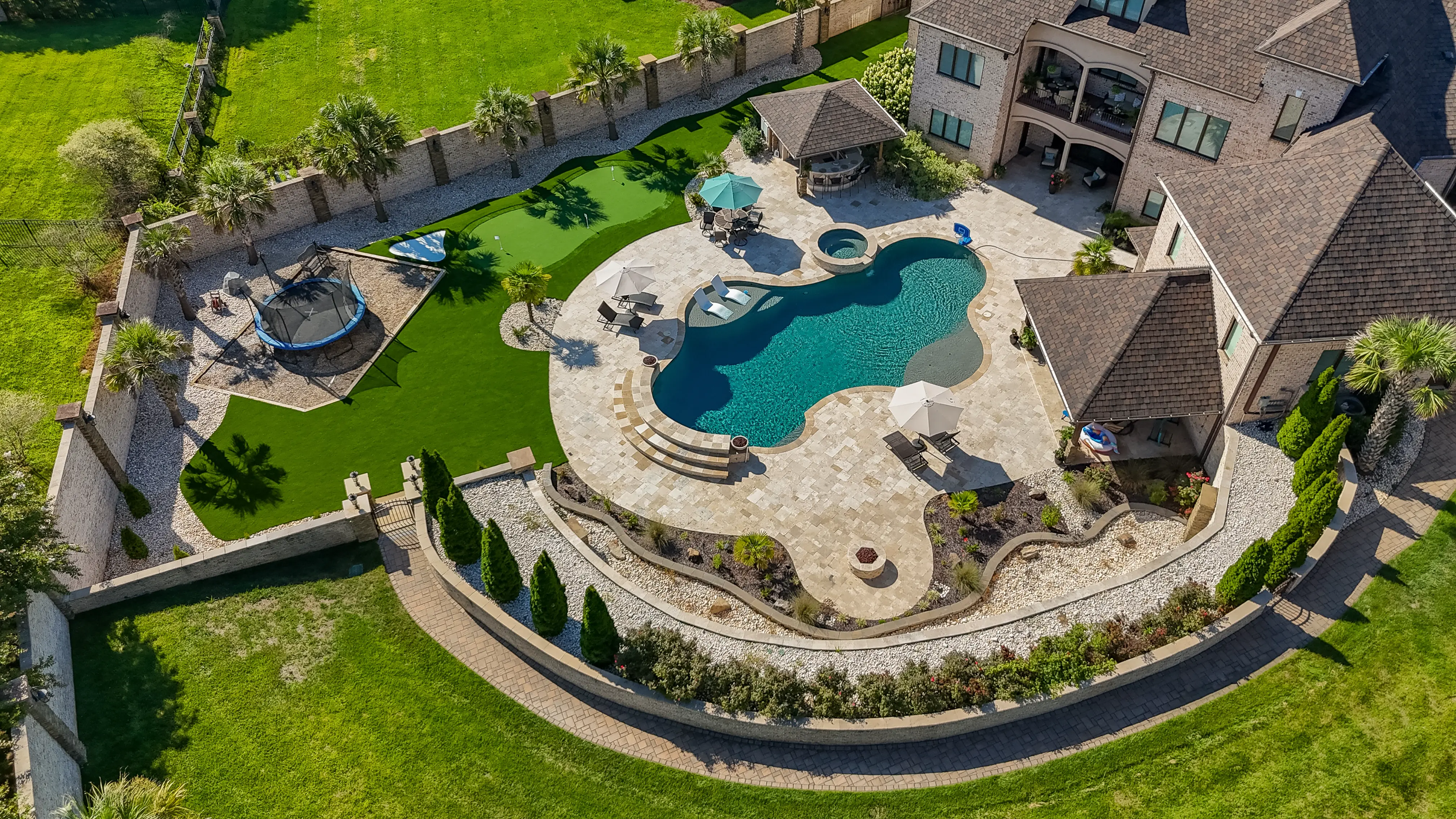 Aerial Luxury Estate: Pool, Turf & Putting Green
