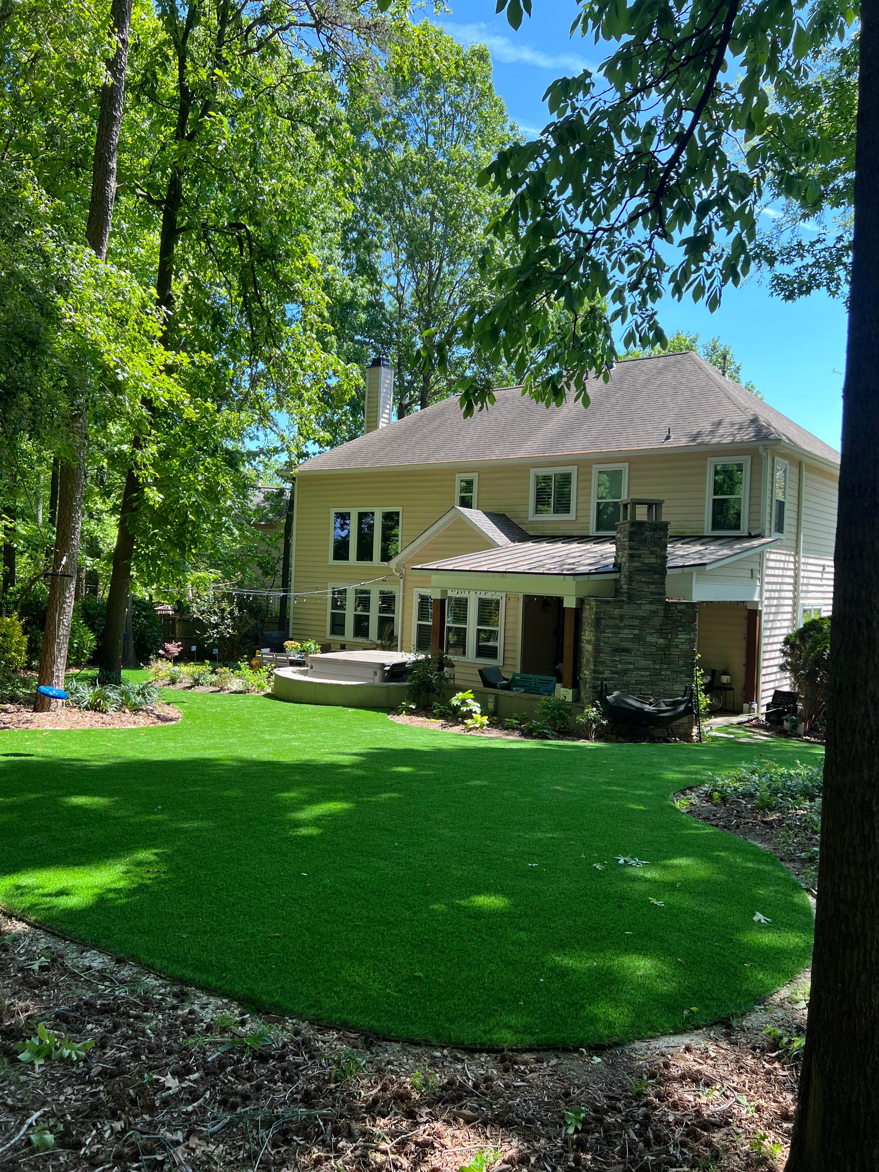 Happy dog enjoying spacious and clean pet-friendly artificial turf lawn in Charlotte NC