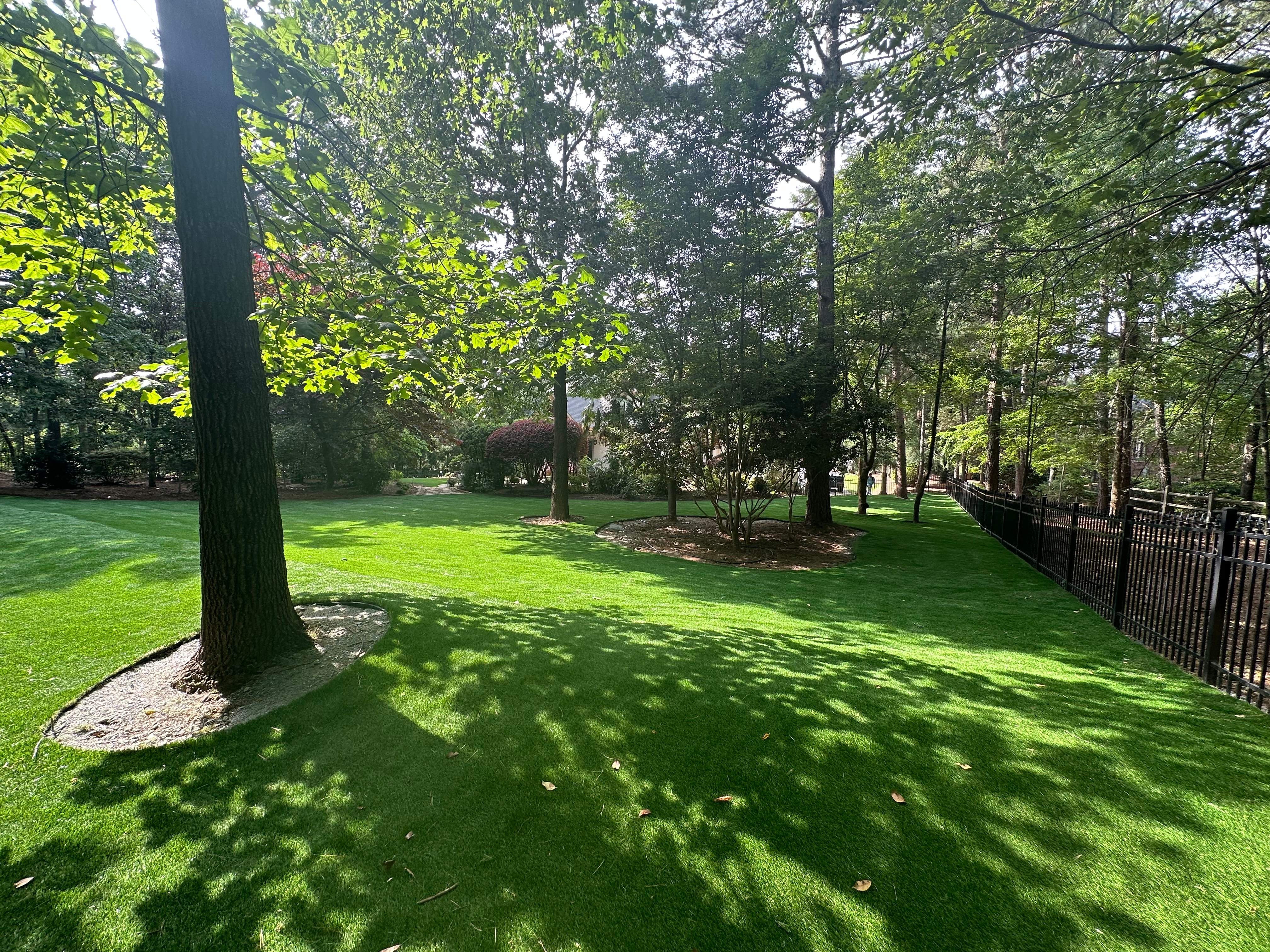 Lush residential artificial turf lawn installation in Charlotte NC backyard